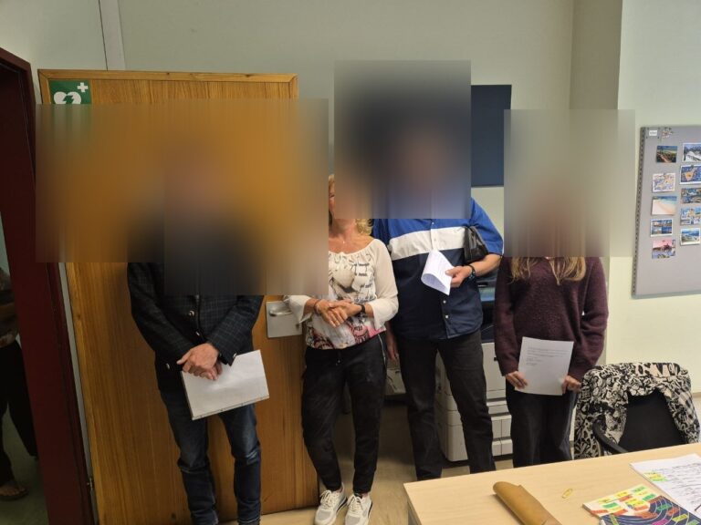 Stolze Absolventen mit Pruefungszeugnis in der Hand