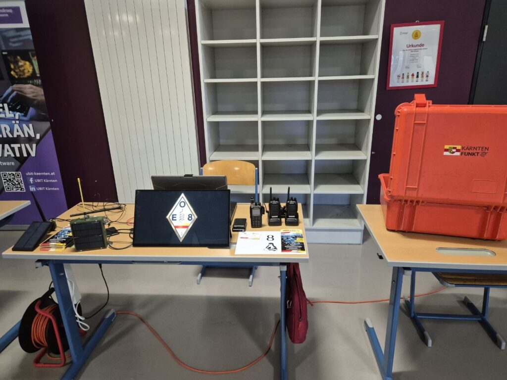 Unser Stand mit KÄRNTEN-FUNKT-Raute auf dem Bildschirm, Funkgeräten und Folder